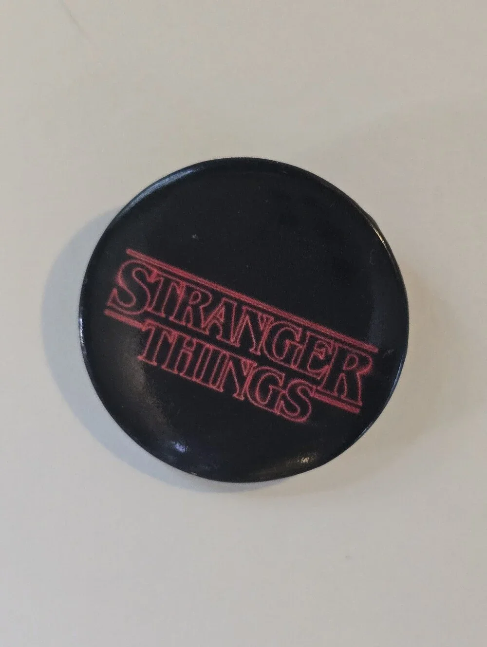 Stranger Things Black Button Pin with Red Logo